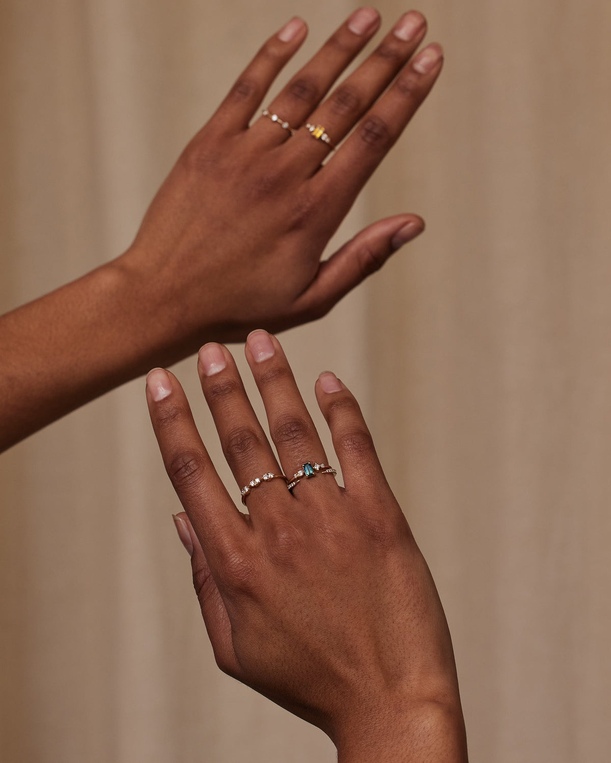 [lifestyle]Two hands with rings on a beige background
