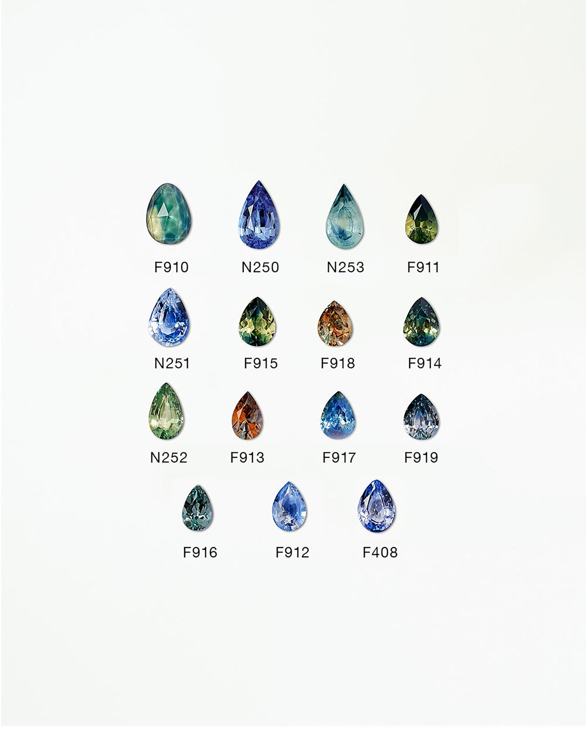 [lifestyle]Collection of various colored teardrop-shaped gemstones on a white background